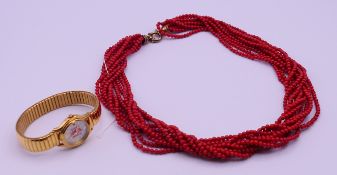 A coral bead necklace and a Citizen ladies' wristwatch. The former 51 cm long.