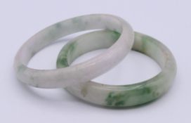 Two jade bangles. The larger 5.5 cm inner diameter.