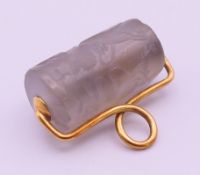 An antique unmarked gold mounted roller seal. 2.4 cm wide.