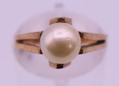 A 9 ct gold pearl set ring. Ring size M. 2.6 grammes total weight.