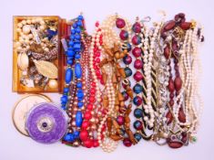 A quantity of various costume jewellery, including necklaces, brooches, earrings, etc. The box 18.