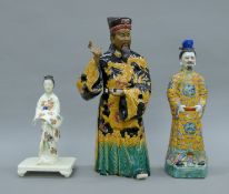 Two Chinese pottery figures and a Japanese porcelain figure. The largest 42 cm high.