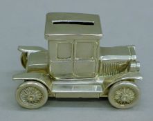 A silver-plated car-form money bank. 11 cm long.