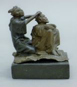 A bronze model of a barber on a marble plinth base. 8.5 cm high.