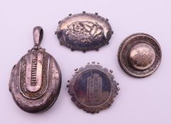 Three silver brooches and a silver locket. The latter 5.8 cm high including suspension loop.