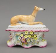 A Victorian Staffordshire porcelain greyhound inkwell. 17 cm long.