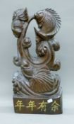 A carved rosewood fish group. 56.5 cm high.