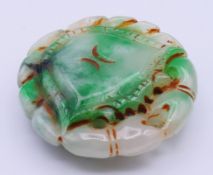 A carved jade crab-form pendant. 5.5 cm diameter.