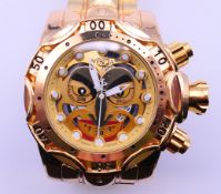 An Invicta gilt gentlemen's wristwatch. 6 cm wide including crown.