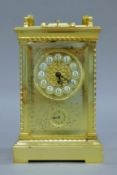 A gilt brass-cased repeating carriage alarm clock. 20.5 cm high overall.