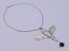 A silver and lapis lazuli scarab pendant necklace. pendant 8.5 cm wide.