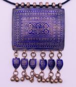 A Persian unmarked silver and enamel pendant necklace. 8.5 cm wide.