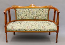 An Edwardian inlaid and upholstered settee. 127 cm wide.
