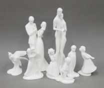 Seven Royal Doulton white porcelain figurines. The largest 33 cm high.