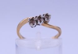 A 9 ct three-stone diamond ring. Ring size I/J. 1.5 grammes total weight.