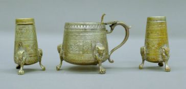 An early 20th century Egyptian Revival silver-plated three-piece cruet set. The mustard pot 7.