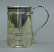 A silver Christening mug with engraved initials and presentation inscription to base. 9.5 cm high.