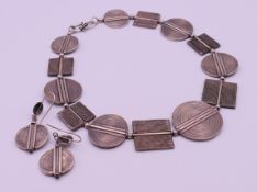 An African unmarked silver necklace and earrings. The former 42 cm long.