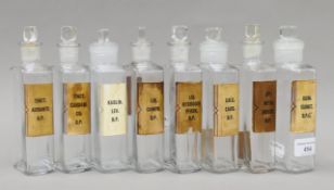 Eight vintage apothecary glass bottles. Each 18 cm high.