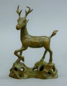 A Chinese bronze model of a deer. 12.5 cm high.