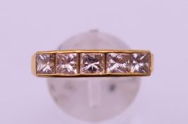 An 18ct gold five stone diamond channel set ring (approximately 1 carat of diamonds). Ring size T/U.