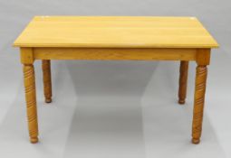 An oak dining table with spirally-turned legs, made by the wood turner Peter Stock. 138 x 86 cm.