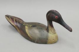 A painted wooden decoy duck. 36 cm long.