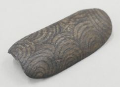An Aboriginal coolamon with geometric carved decoration. 14 cm long.