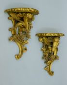 A pair of resin wall brackets. Each 33 cm wide.
