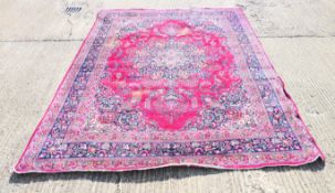 A large red ground wool rug. 385 x 285 cm.