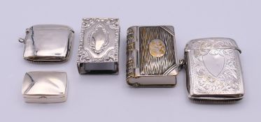 A silver match box cover, a silver pill box, a silver vesta and two silver-plated vestas.
