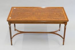 A modern yew wood veneered coffee table. 94 cm long.