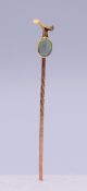An unmarked gold and opal stickpin. 5.5 cm long. 1.1 gramme total weight.