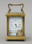 A brass-cased porcelain-mounted carriage clock. 11.5 cm high overall.