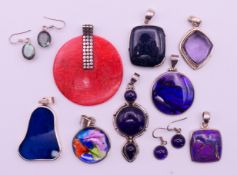 A quantity of stone-set pendants and earrings. The largest 5 cm diameter.