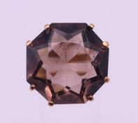 A 9 ct gold ring set with an octagonal stone, possibly a smoky quartz. Ring size N. 8.