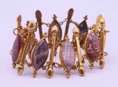 A gilt metal and hardstone bracelet. 18 cm long.