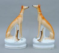 A pair of Victorian Staffordshire high and mighty coursing greyhounds. Each 31 cm high.