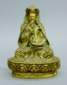 A gilt bronze Buddha figure with phurba. 19.5 cm high.