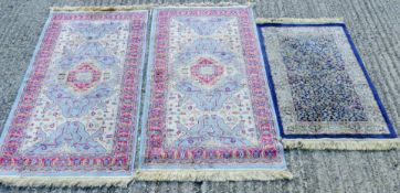 Three small blue Kashmir rugs. The two largest each 148 x 69 cm, the other 113 x 59 cm.