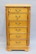 A modern pine chest of drawers. 67 cm wide x 124 cm high.