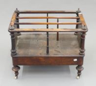 A Victorian walnut Canterbury. 60 cm wide.