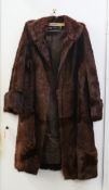 A Swan & Edgar ladies' fur coat. Length 107 cm and approximate bust 112 cm.