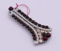 A Czechoslovakian Art Deco paste and simulated garnet brooch. 7 cm high.