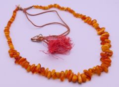 An amber bead adjustable necklace. Maximum length 106 cm long, larger beads approximately 2 cm high.