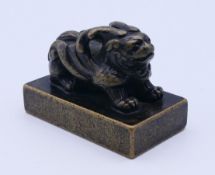 A bronze seal surmounted with a mythical beast. 7 cm long.