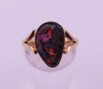 A 9 ct gold and black opal ring. Ring size N. 4.1 grammes total weight.