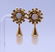 A pair of 18 ct gold and opal earrings (dangles unclip to convert to flower studs). Each 3.