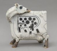 LAWSON E RUDGE (born 1936) (AR), a raku-fired studio pottery sculpture of a cow. 26.5 cm high.