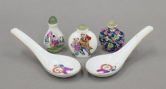 Three Chinese porcelain snuff bottles and two Chinese porcelain spoons. The latter each 14 cm long.